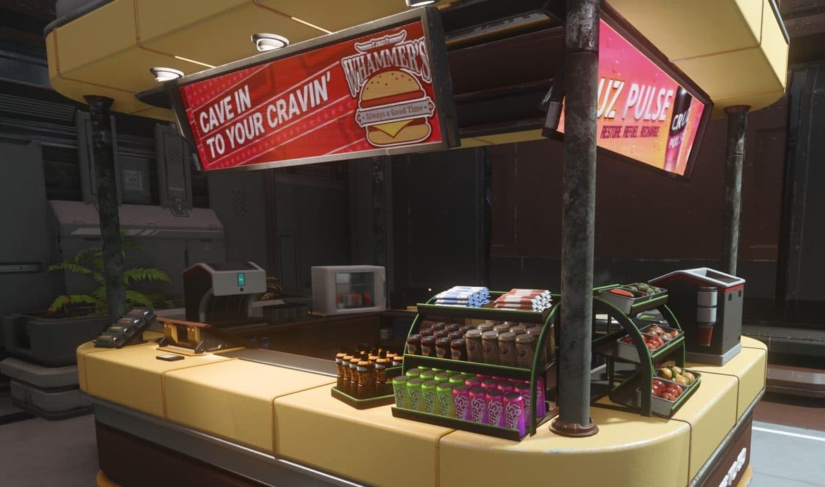 A vending machine at a space station common area stocked with drinks and snacks for purchase.